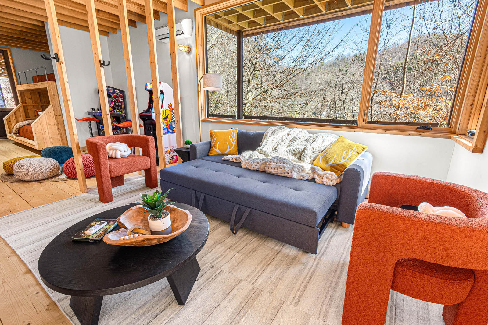 The main level den serves as a living room, entertainment center, adjacent to gaming and bunk beds. Perfect for teens or a group of friends.