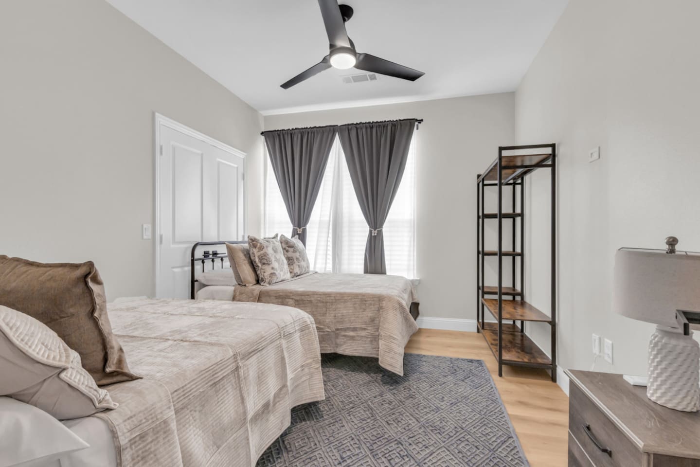 Secondary bedroom with 2 full bed and chic rug styling.