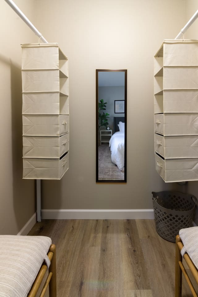 A quiet corner of the bedroom, with warm wood floors and simple, cozy styling.