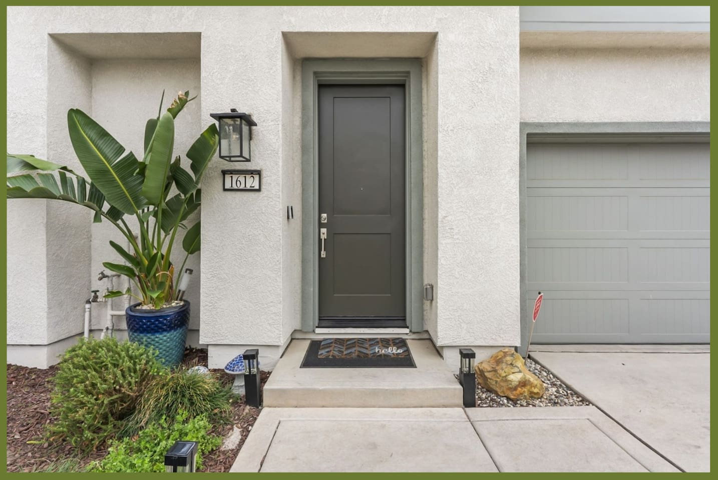 Front entry with garage access, covered doorway, and simple landscaping for an easy arrival.