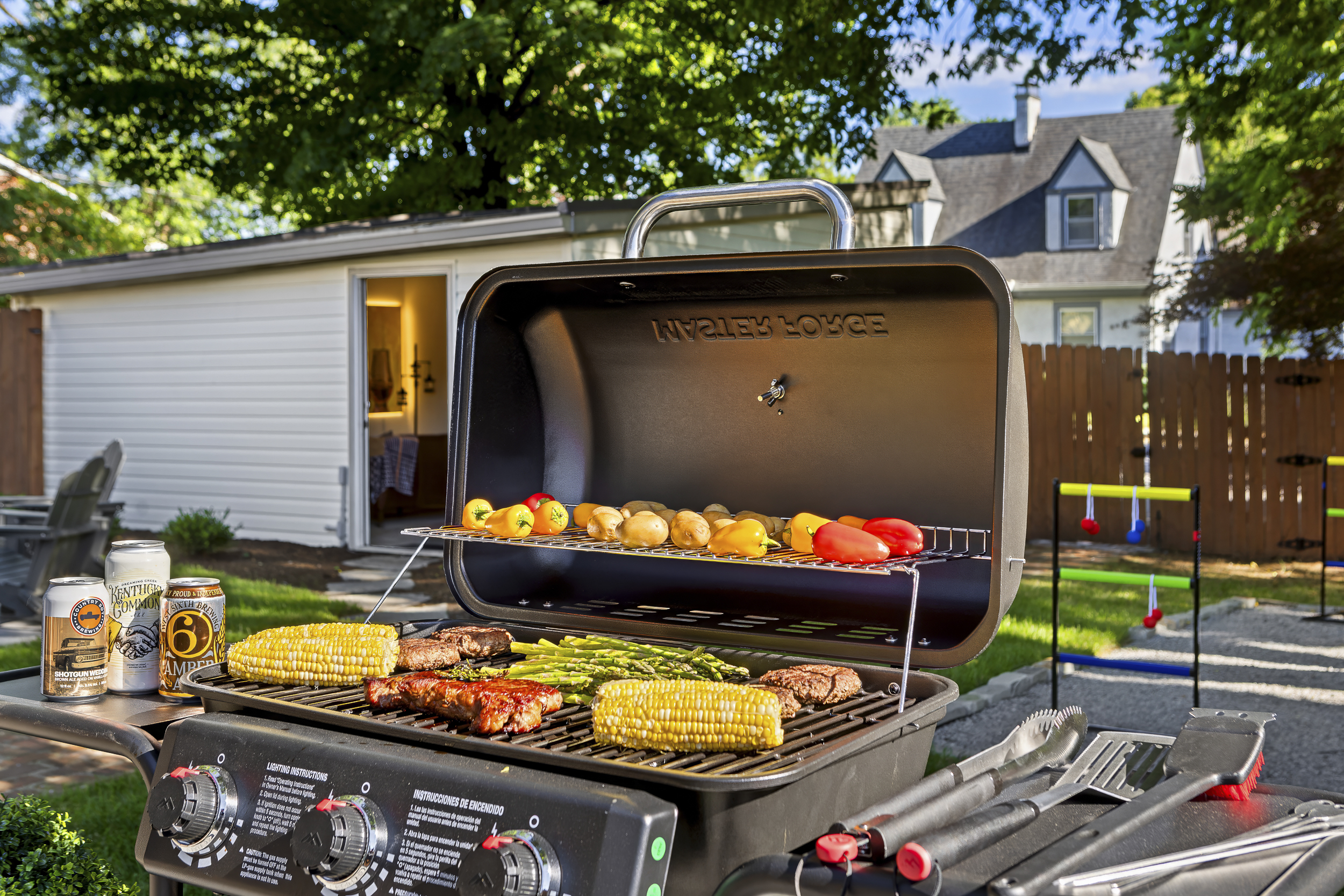 The backyard Weber is fired up for a proper Kentucky cookout, with corn, ribs, peppers, and asparagus sizzling on the grill.
