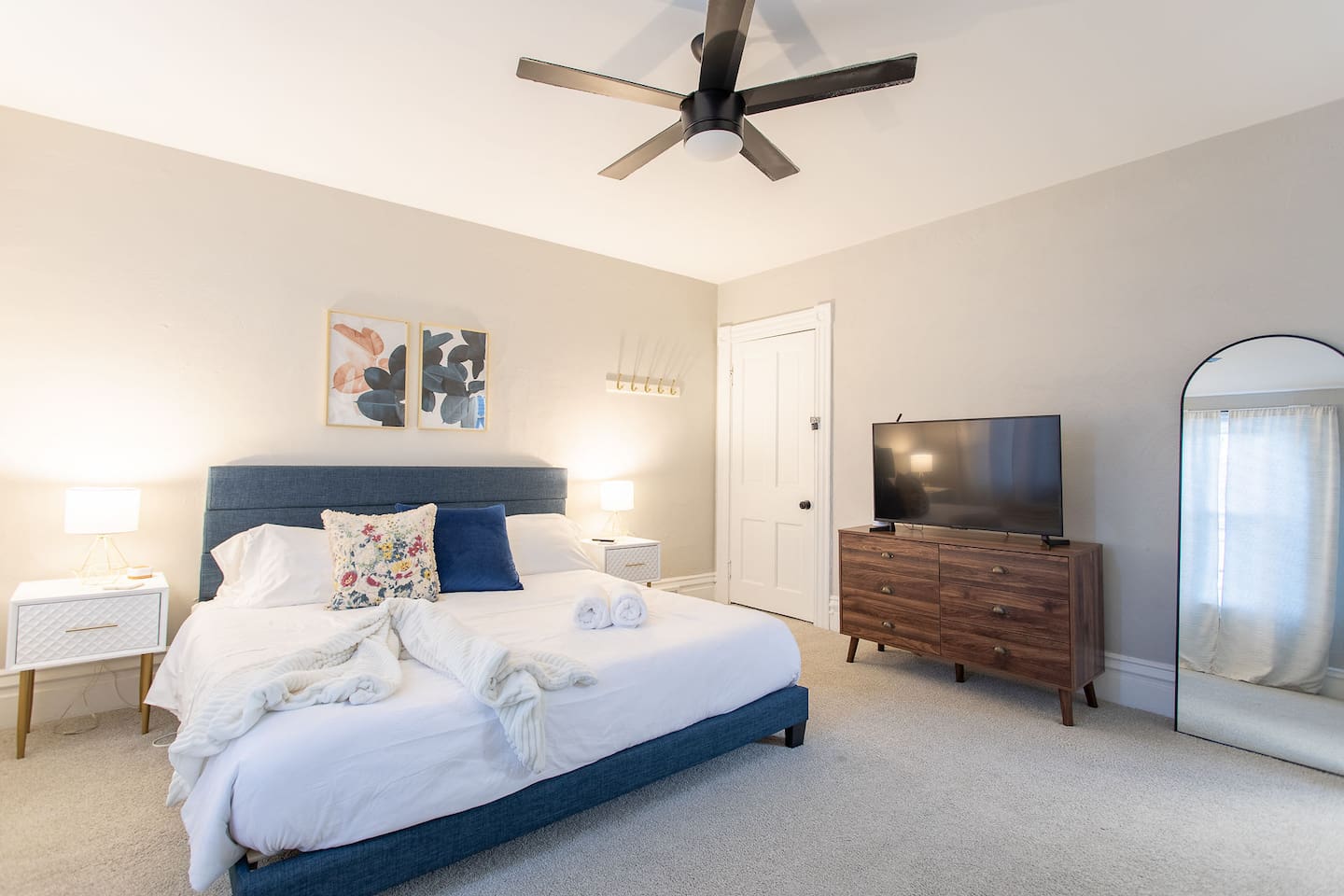 Discover the King Bedroom, a spacious room on the second floor with king bed flanked by nightstands with lamps.