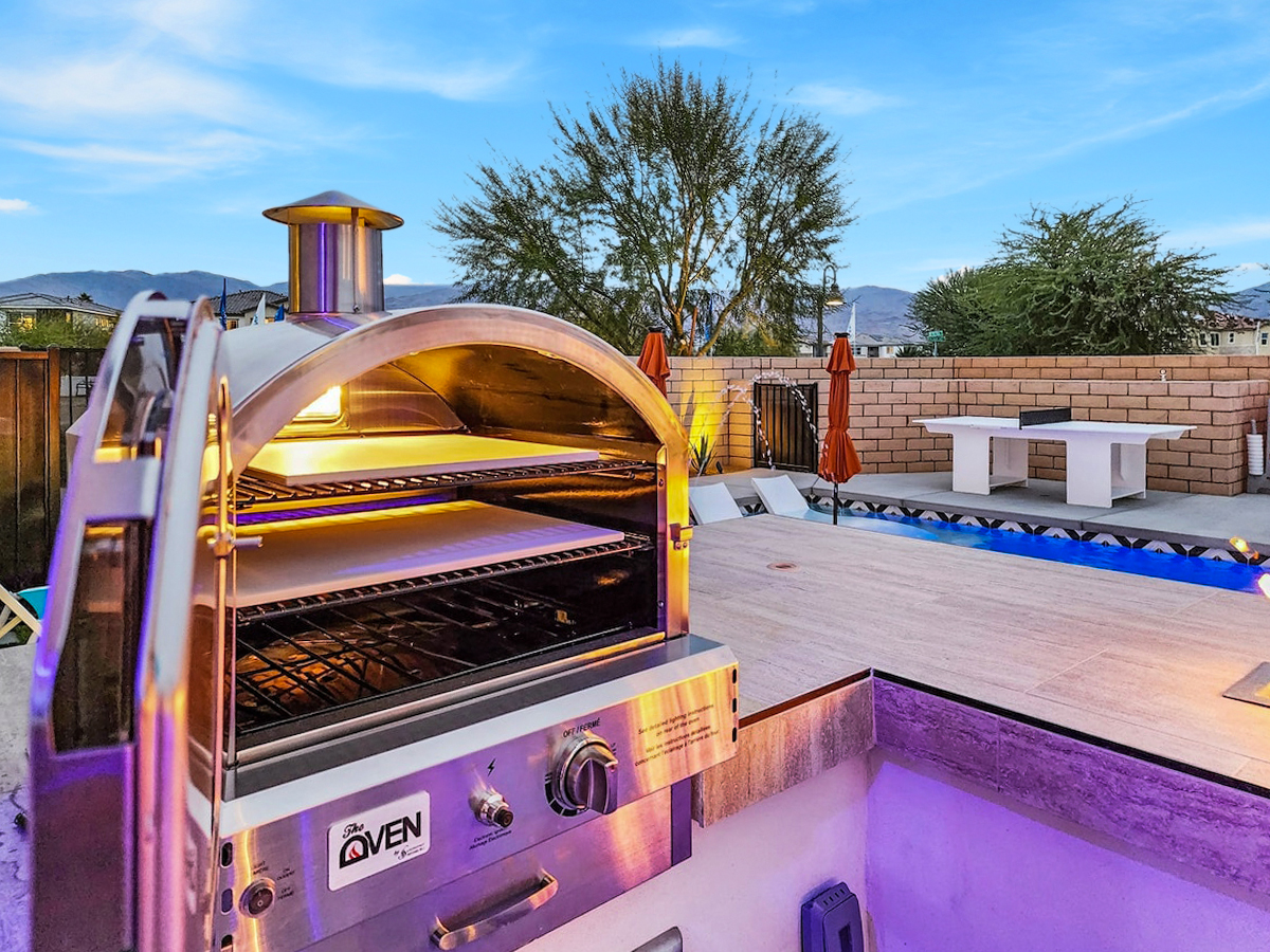 Outdoor Oasis: Fire up the pizza oven and savor delightful meals poolside under vibrant skies!