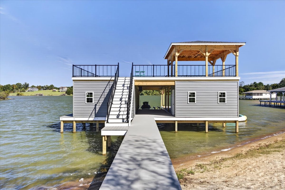 Private walkway leads directly from the sandy shoreline to the spacious boathouse.