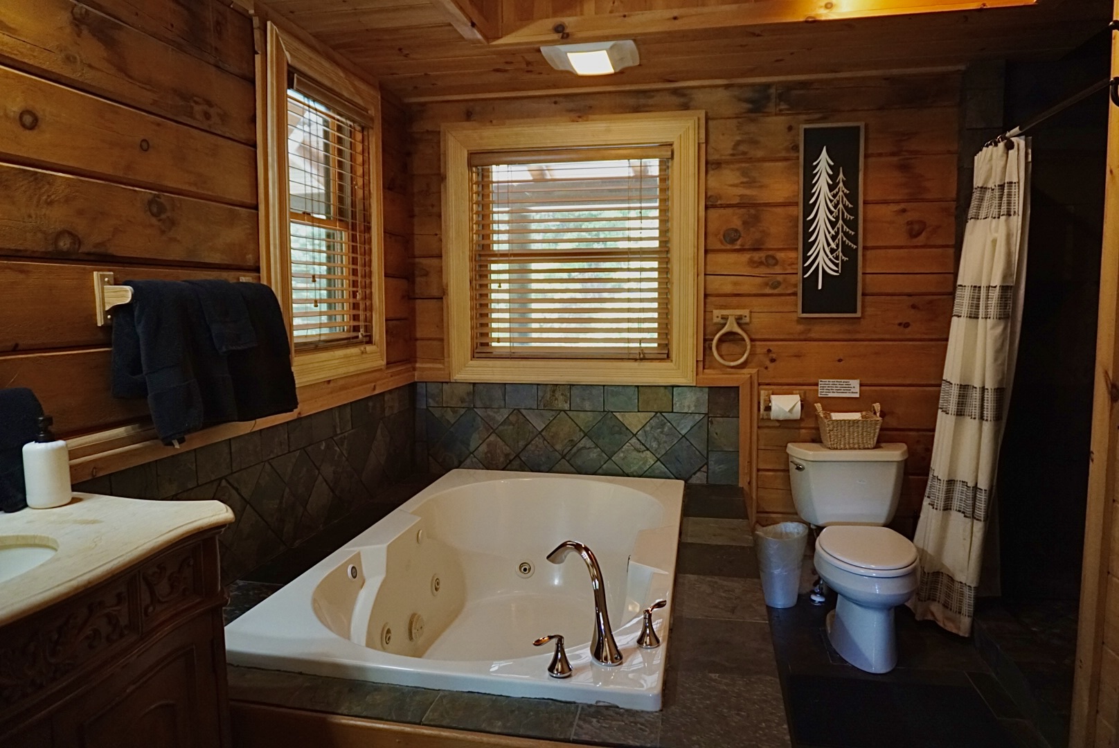 Spa-Like Retreat: Enjoy relaxation in a stylish bathroom featuring a jetted tub and rustic charm!