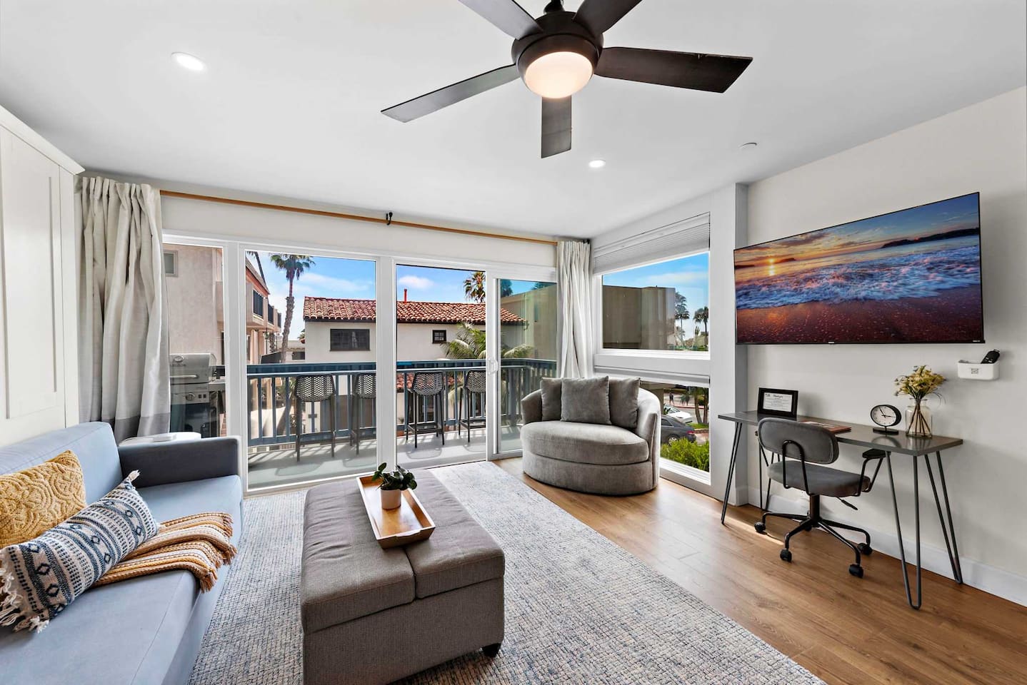 A comfortable living room with plenty of seating and a king-sized sofa Murphy Bed that converts to a "real bed with a premium mattress" in less than one minute.  The bed is made up with premium bedding ready for sleep