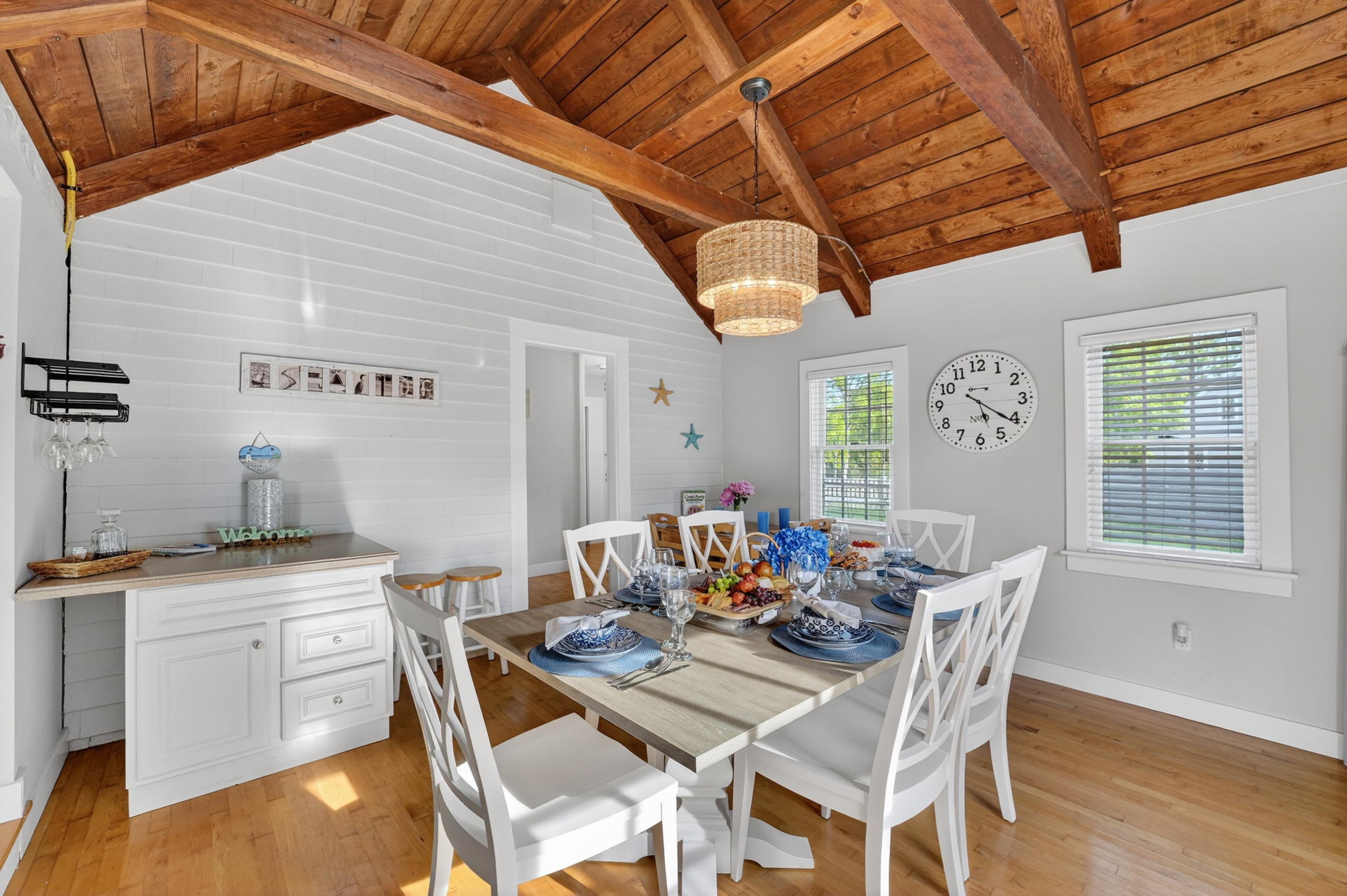 Spacious dining room with vaulted ceilings and coastal-inspired décor, creating the perfect setting for group gatherings.