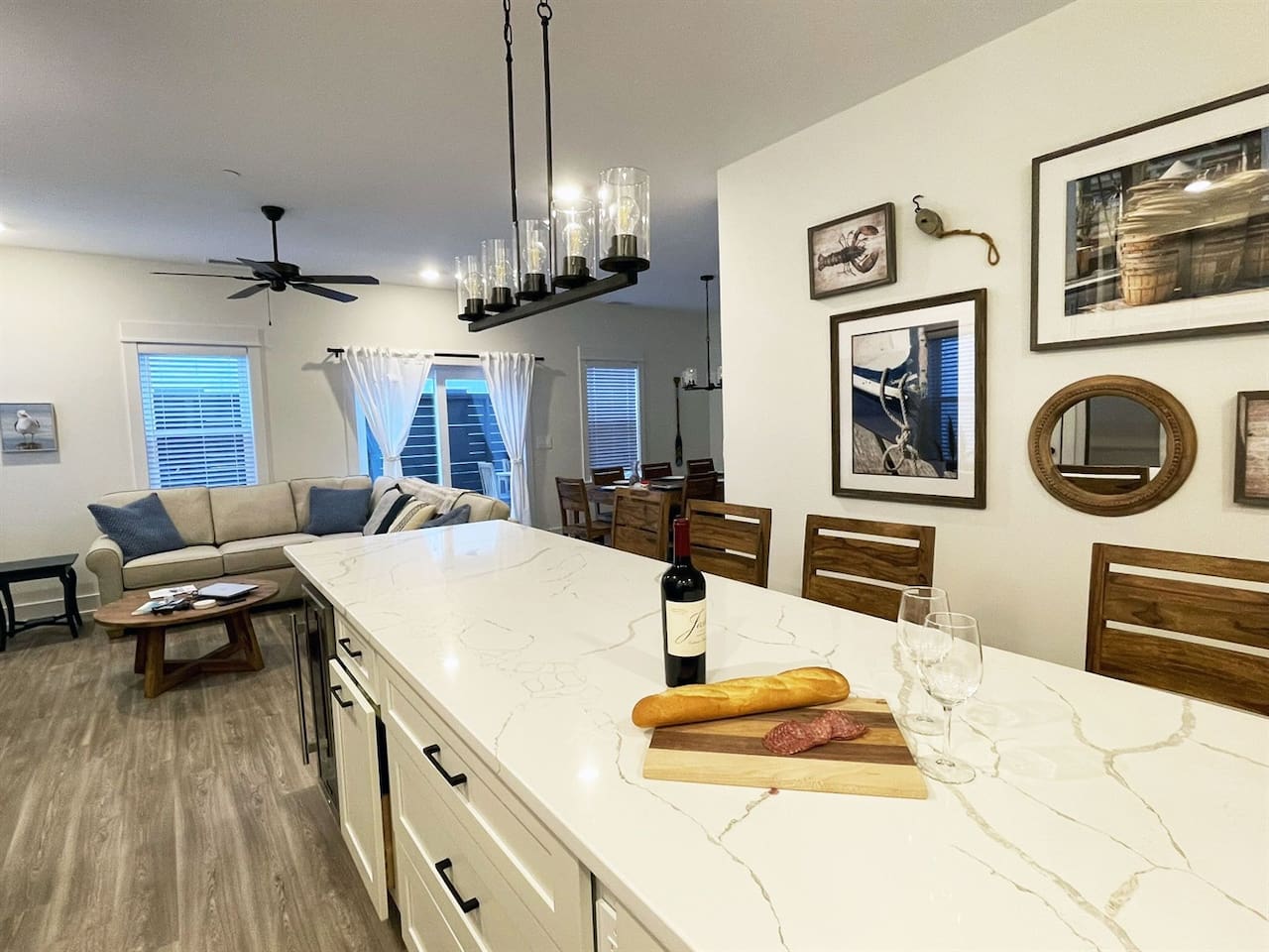 Spacious open floor plan featuring a fully equipped kitchen, dining area, and comfortable living room designed for gathering and relaxing together.