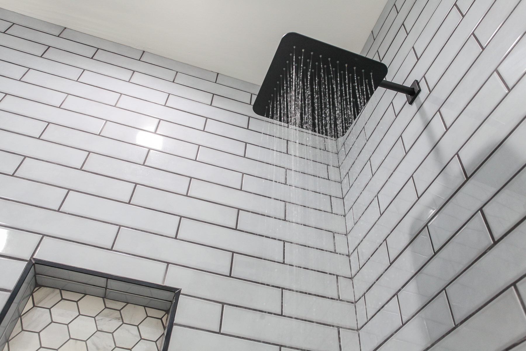 Refresh after a day exploring in the primary bathroom’s tiled shower with a rainfall shower head at Robbin’s Nest on Snowbird Creek.
