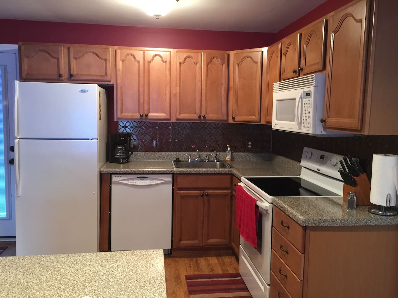 Kitchen stocked with pots and pans, spices, microwave, dishwasher, disposal, ice maker, coffee pot, refrig, electric range, and more!