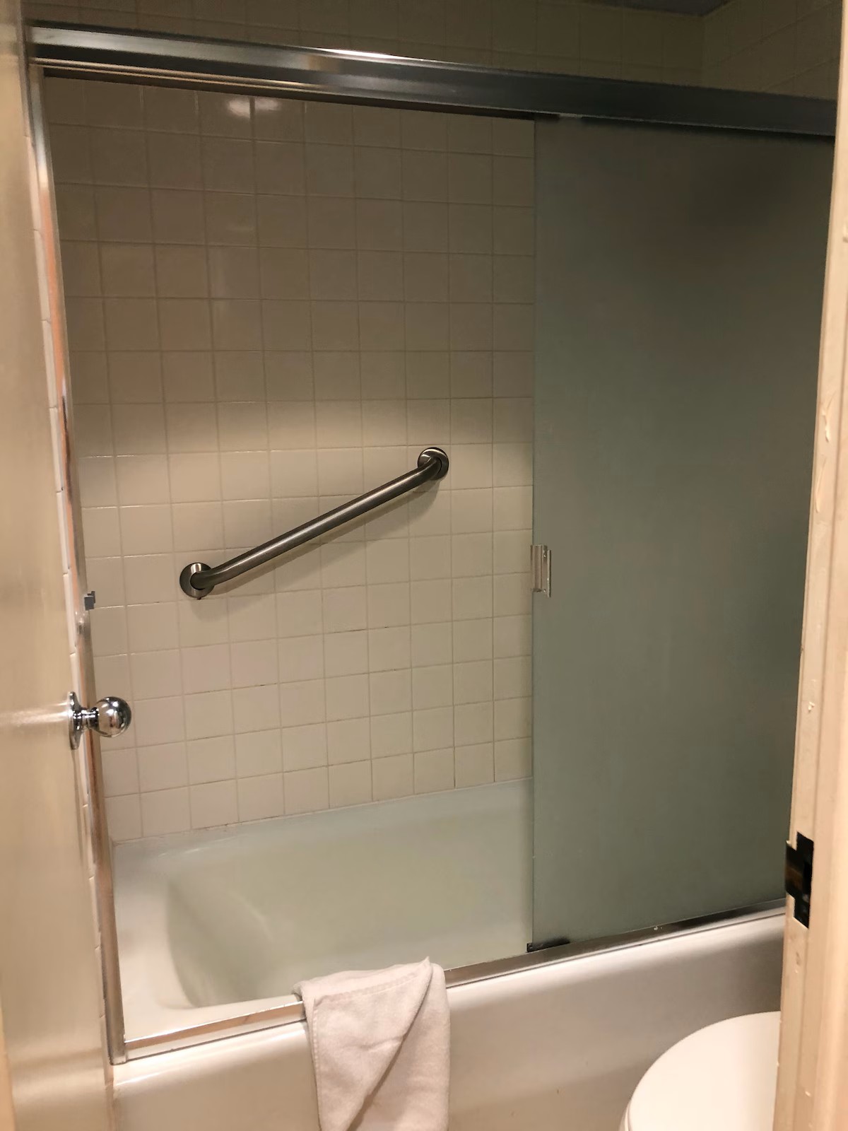 Clean bathroom with shower-tub combination