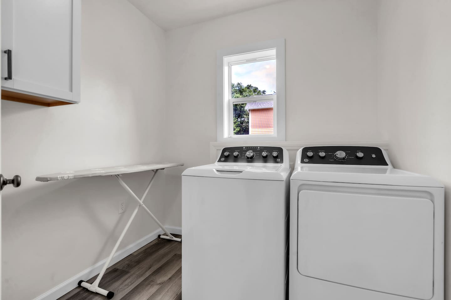 This laundry area features a washer, dryer & iron board, offering everything you need to keep your clothes looking their best while traveling.