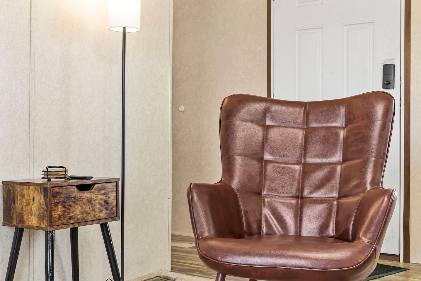 Stylish accent chair and reading nook near the entry—ideal for unwinding after a long day.