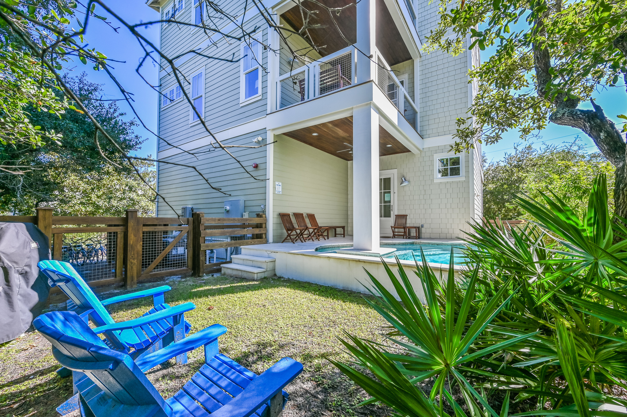 Private yard with Adirondack chairs.