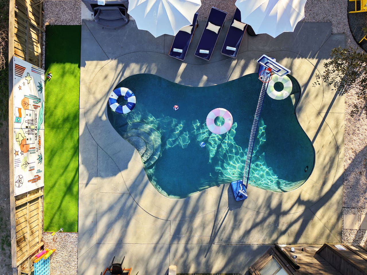 Aerial view perfection ⛱️  
Dive into fun with a private pool, poolside basketball & volleyball, and your own putting green right next door!
