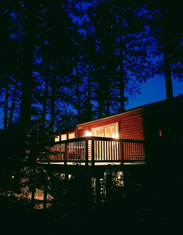 The home glows beautifully at night, creating a warm and inviting outdoor space under the stars.  