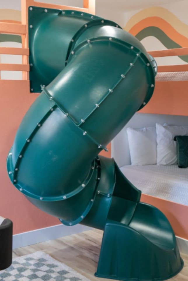 Why take the stairs when there's a slide? This built-in tube turns "time for bed" into the best part of the day, top bunk to floor in three seconds flat.
