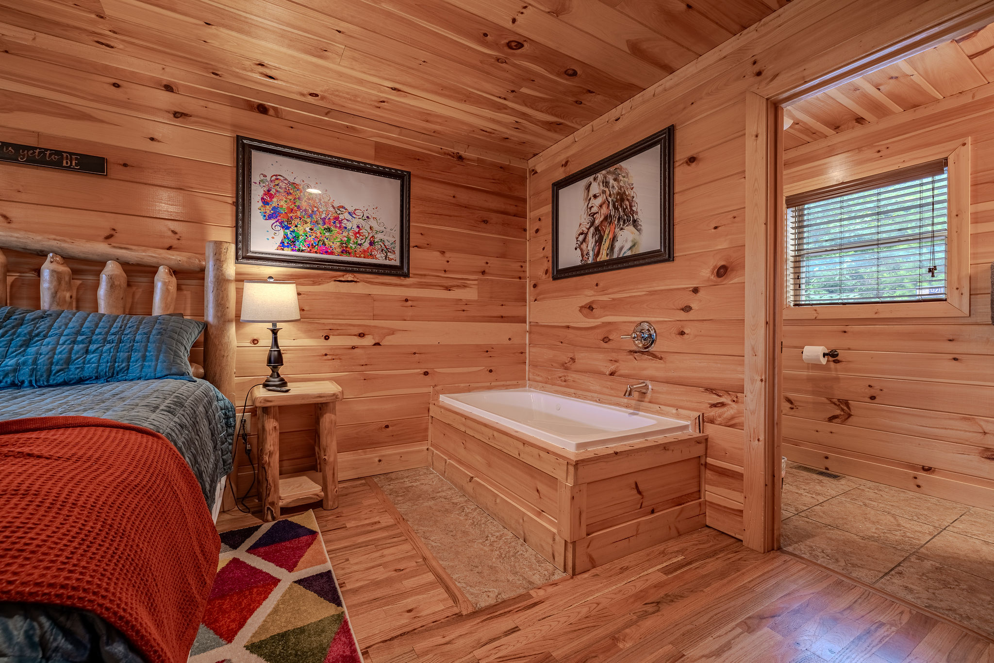 The Headliner Suite is the main-level king bedroom, offering convenient access to the living room, kitchen, dining area, and deck.