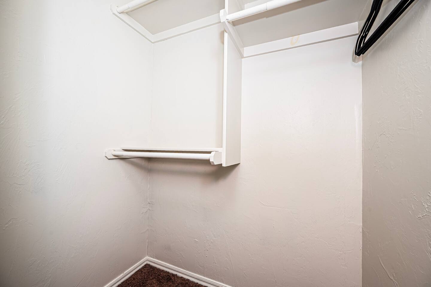 Spacious walk-in closet connected to master bathroom.