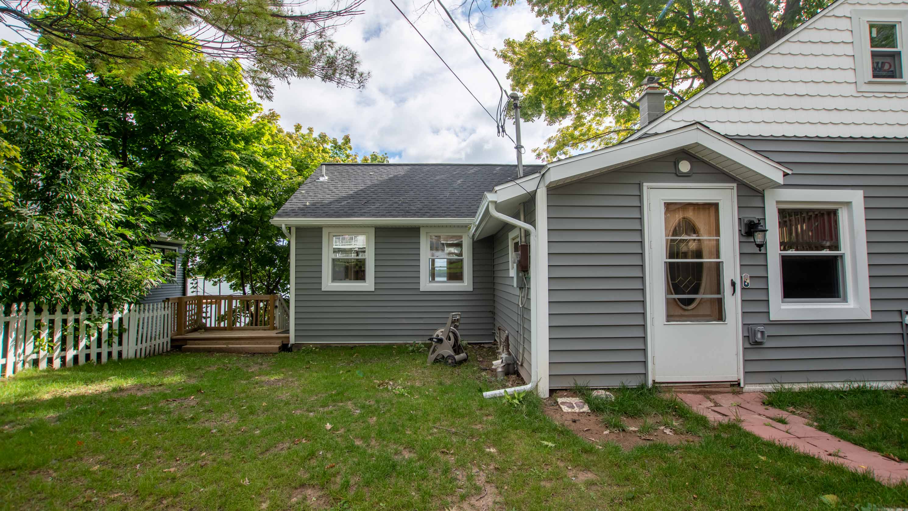 Side view of the home showcasing outdoor space and easy deck access.