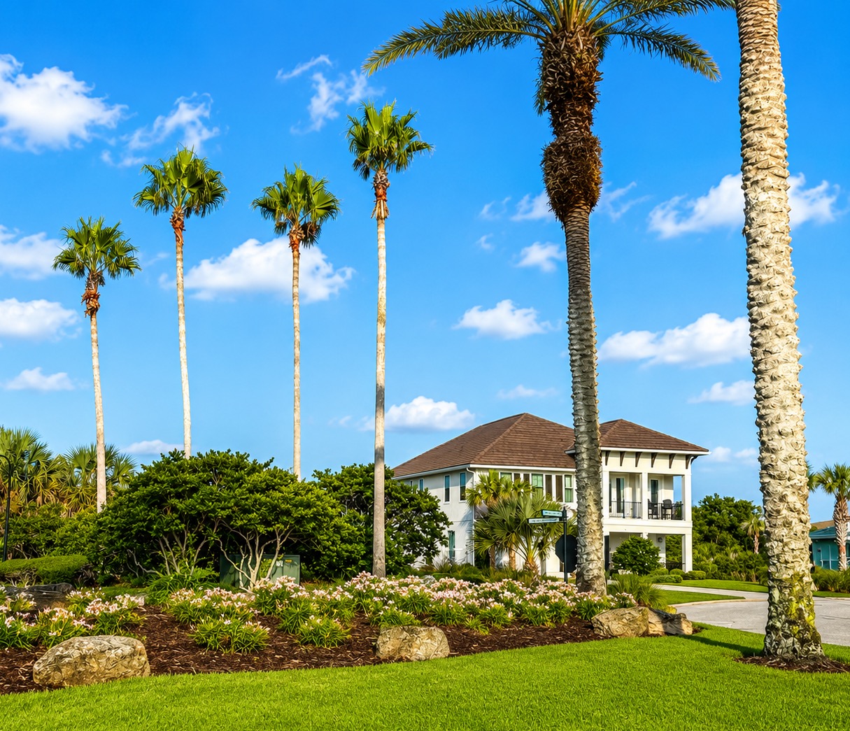 Welcome home for the week. Framed by swaying palms and endless blue Florida sky, this stately coastal retreat is where your family's story unfolds—arrivals full of anticipation, hugs on the porch, and promises to return before you've even left.