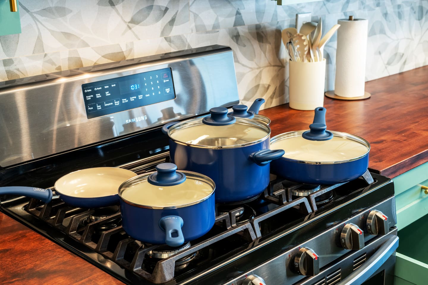 Cookware that blends function and style — non-stick pots and pans with a clean, wood-accented finish.