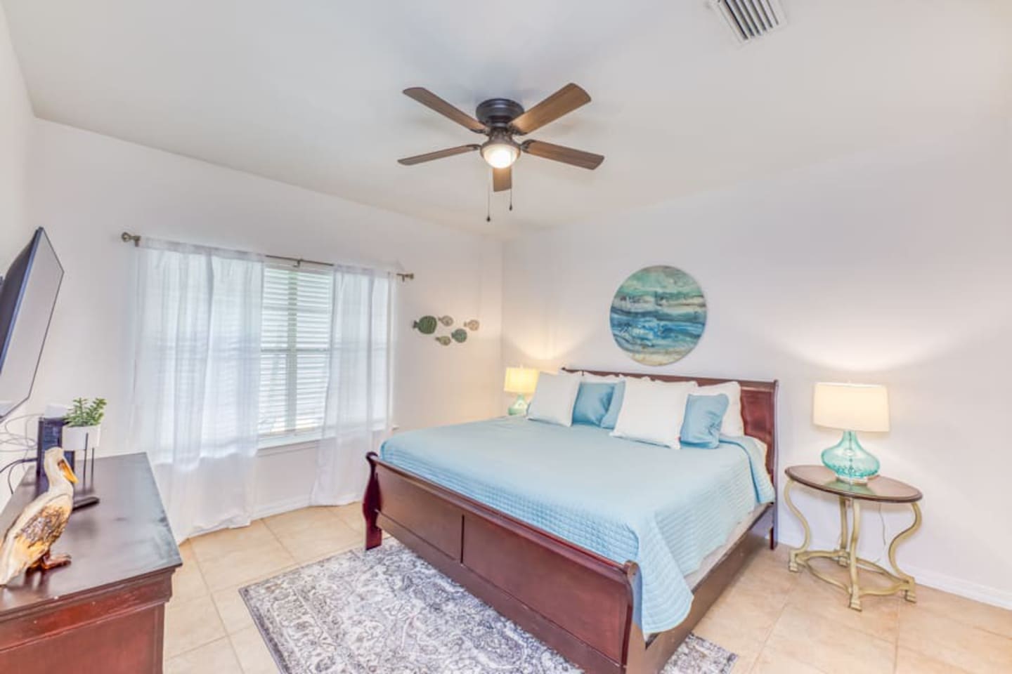 Bedroom Retreat: Beachy decor meets modern comfort in this sunlit escape. Perfect for relaxation!