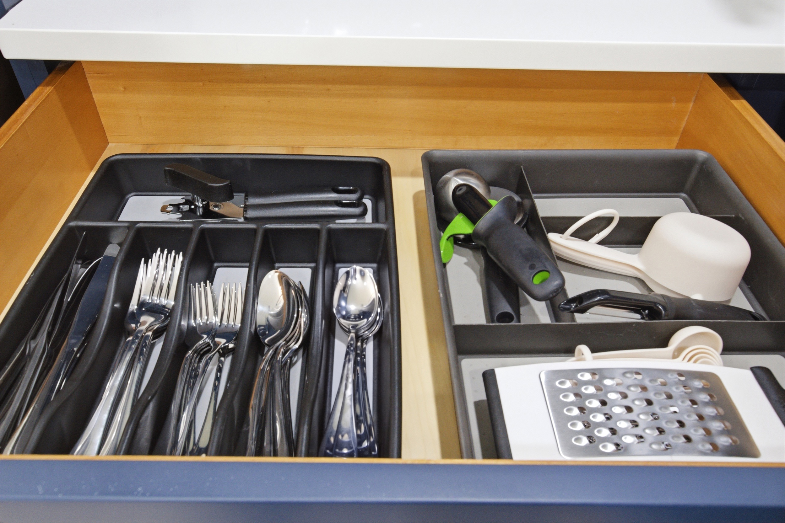 Cutlery Drawer stocked with Dishes, Silverware, and Cooking Utensils. Fully Equipped Kitchen ready for group dinners and morning breakfasts.

