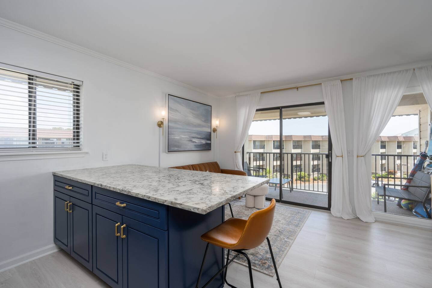 Updated kitchen featuring quartz countertops, new cabinets, new appliances, and island that seats three. A well equipped kitchen with everything you need for cooking during your stay!