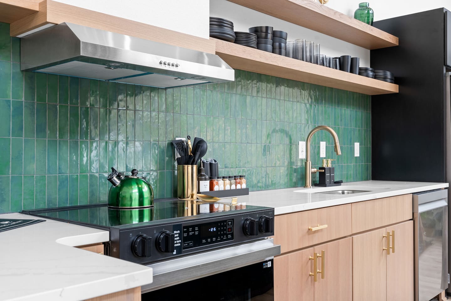Kitchen Delight: Cook up a storm in this stylish kitchen with vibrant green tiles and modern flair!