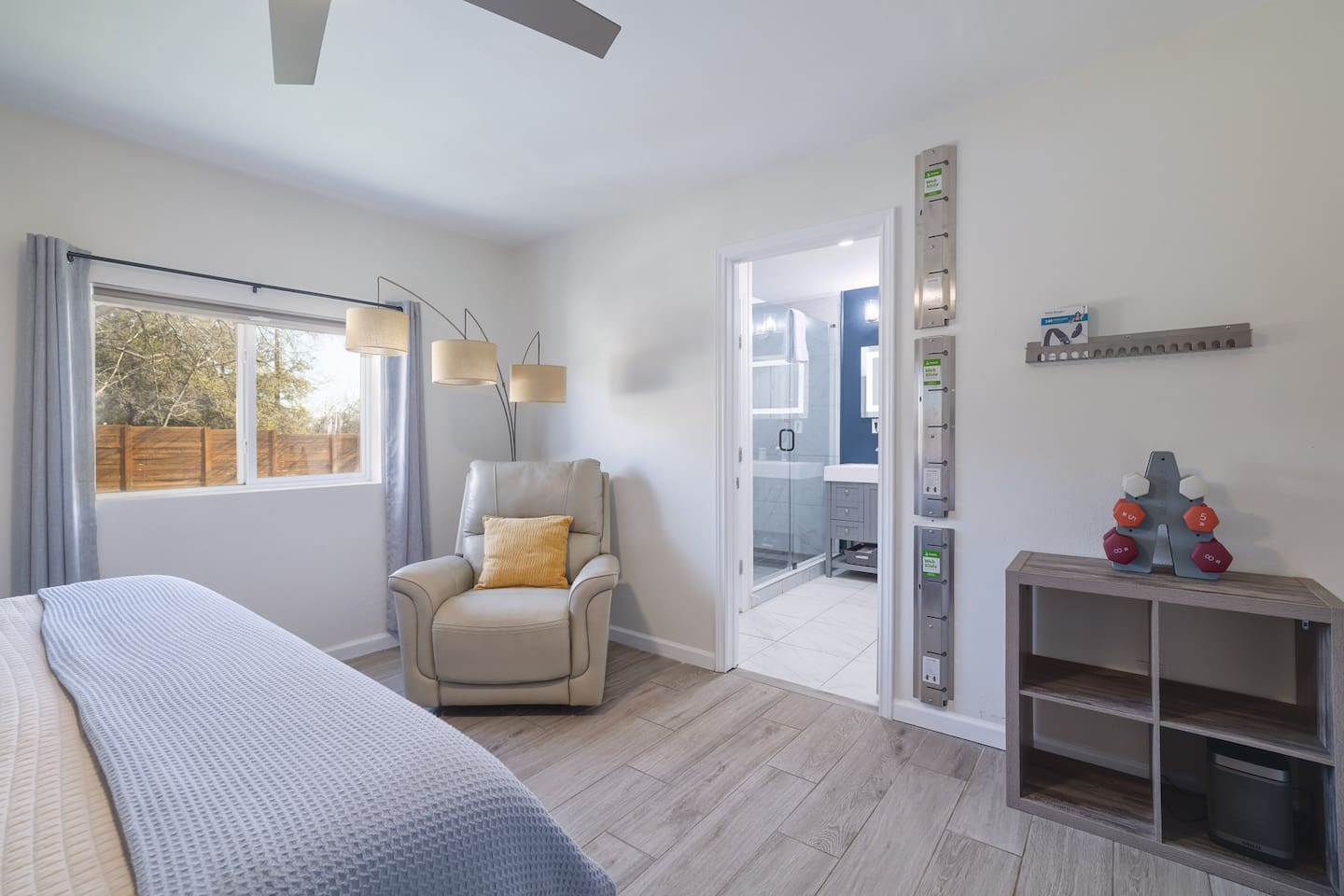 Unwind in this spacious downstairs retreat featuring a cozy reading chair, calming natural light, and easy access to the spa-like ensuite bathroom. Thoughtfully designed for comfort, rest, and slow vacation mornings.