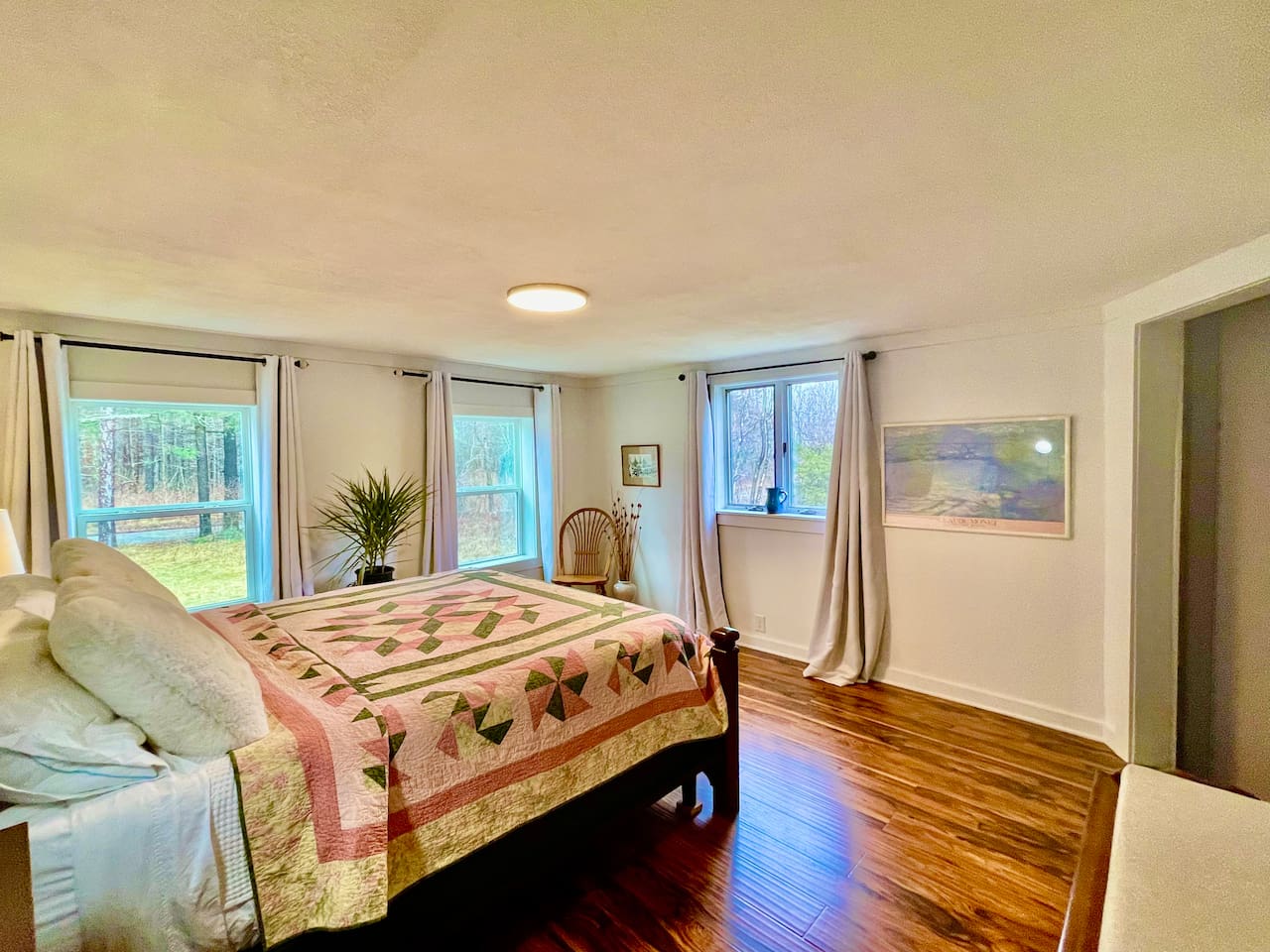 Comfy mattress and cotton sheets atop a California King mattress. Blackout curtains for sound sleep. (second view of lower bedroom)