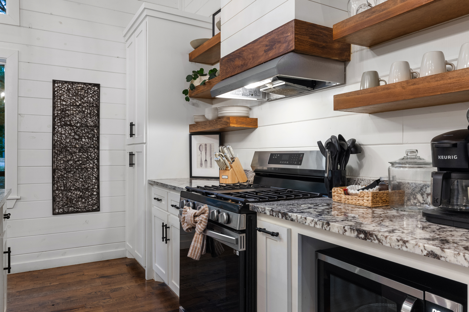 Enjoy a fully equipped space with a gas stove, Keurig, drip coffee maker, cookware, wine glasses, utensils, and everything needed for slow breakfasts and cozy cabin dinners.