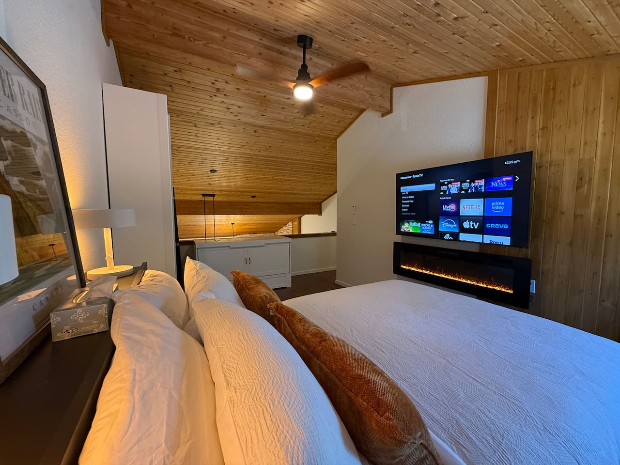 Loft Bedroom Entertainment: Stream your favorite shows on the smart 65" TV enjoying the ambiance of the fireplace. 