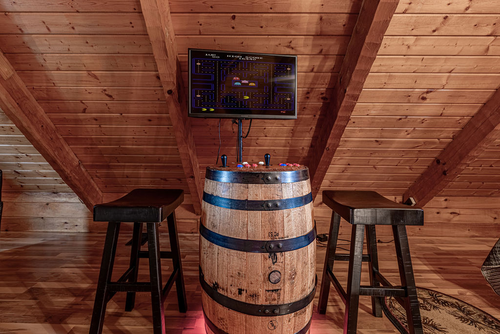 Challenge a friend to classic arcade games in this unique loft game nook.