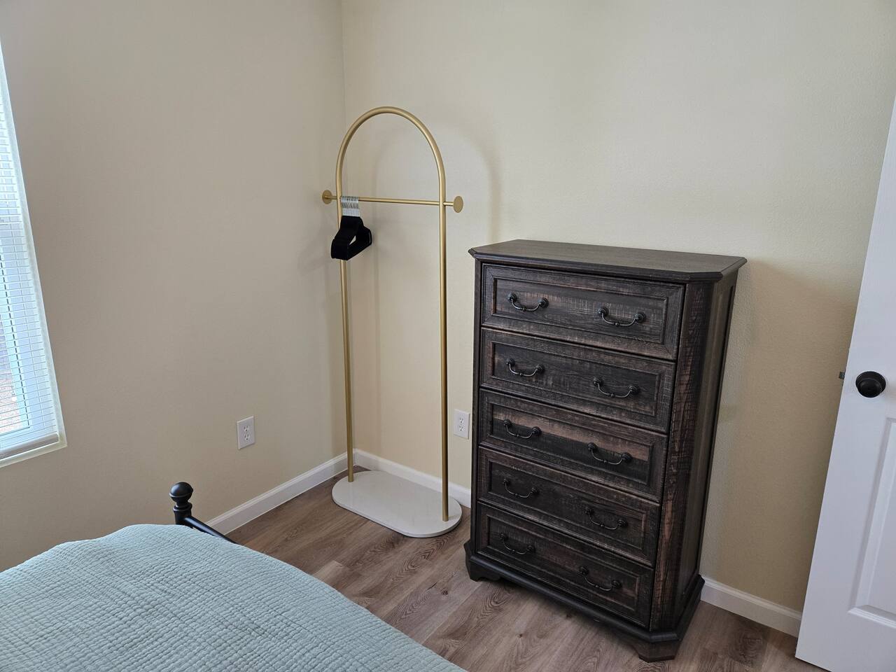 Queen bedroom dresser and clothes rack.
