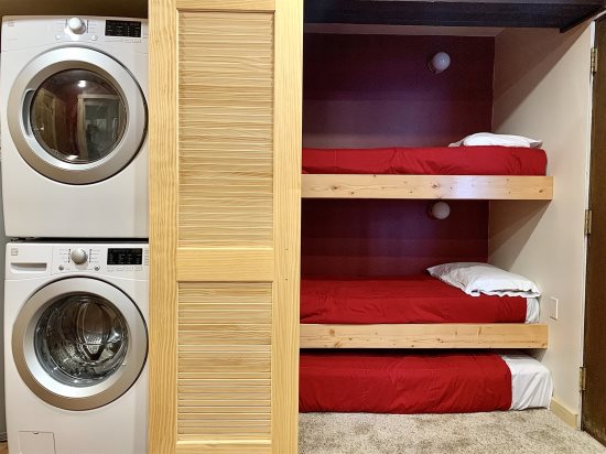 Stack-washer/dryer next to bedroom. 