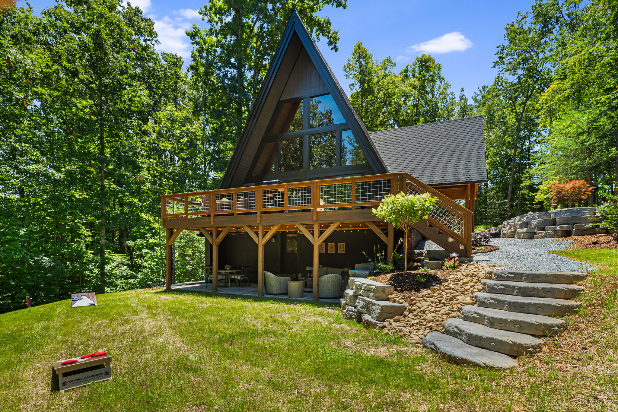 Relax on the spacious the deck overlooking the trees and backyard, and cozy evenings on the covered patio with string lights and super comfortable furniture that invites you to unwind and recharge. 