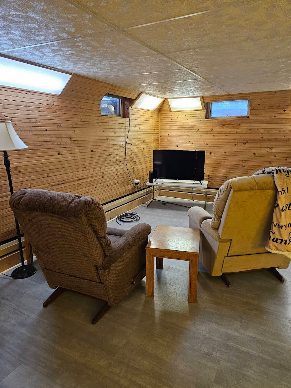 Sitting area with Roku smart TV next to basement bedroom