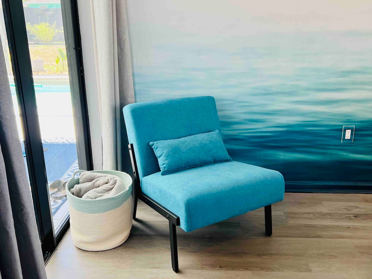 Every detail pops at this artistic Spring Hill Airbnb! Featuring a modern chair overlooking the pool that blends in with the wall mural- perfect for photo ready stays! #instaworthyvibes #aestheticstay #springhillAirbnb 