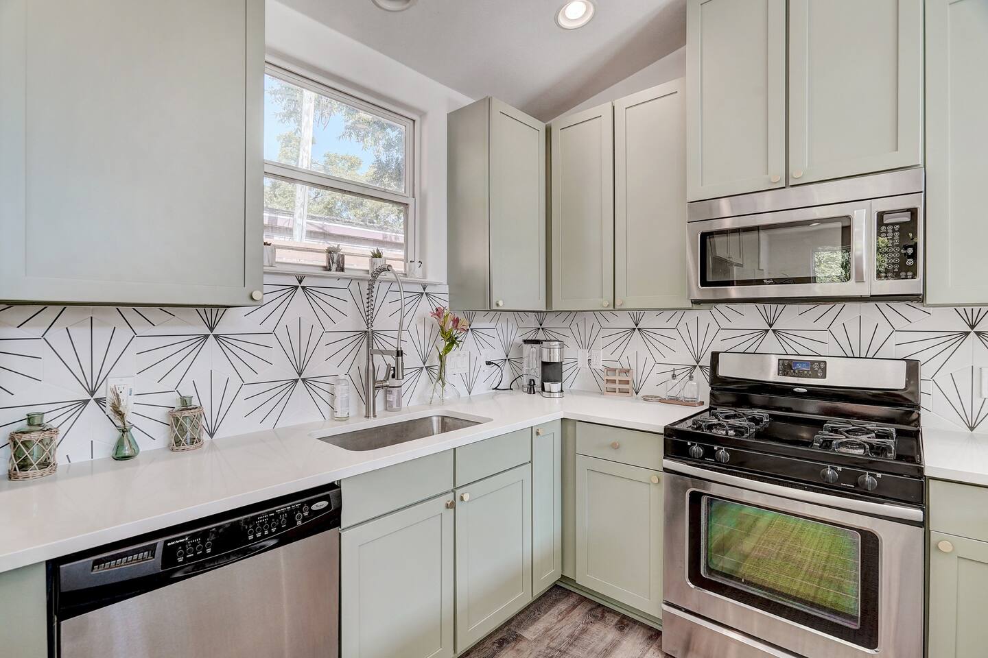 Furnished kitchen with stainless steel appliances and tiled countertops perfect for cooking large meals!