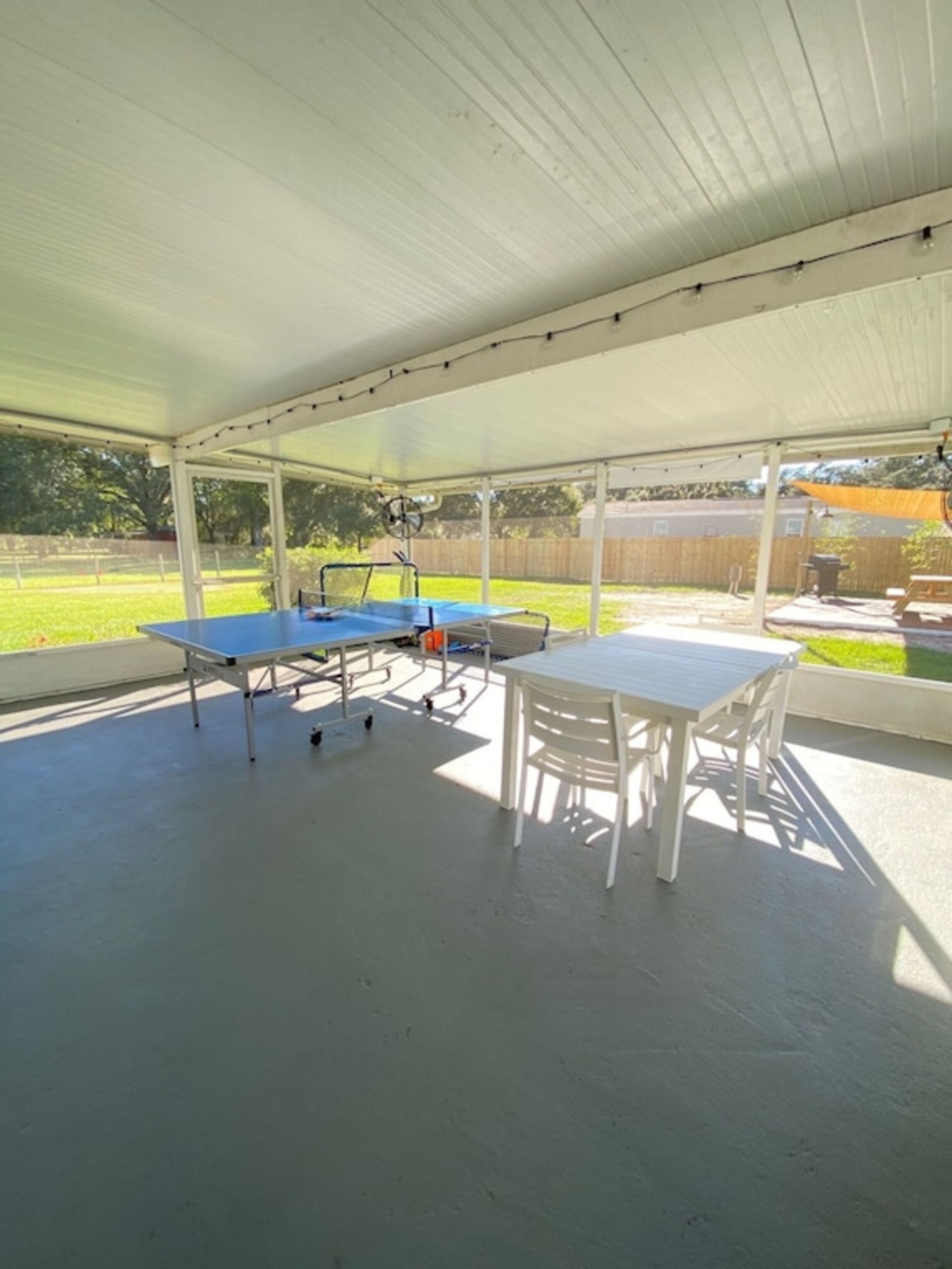 spacious screened porch outside seating with fans