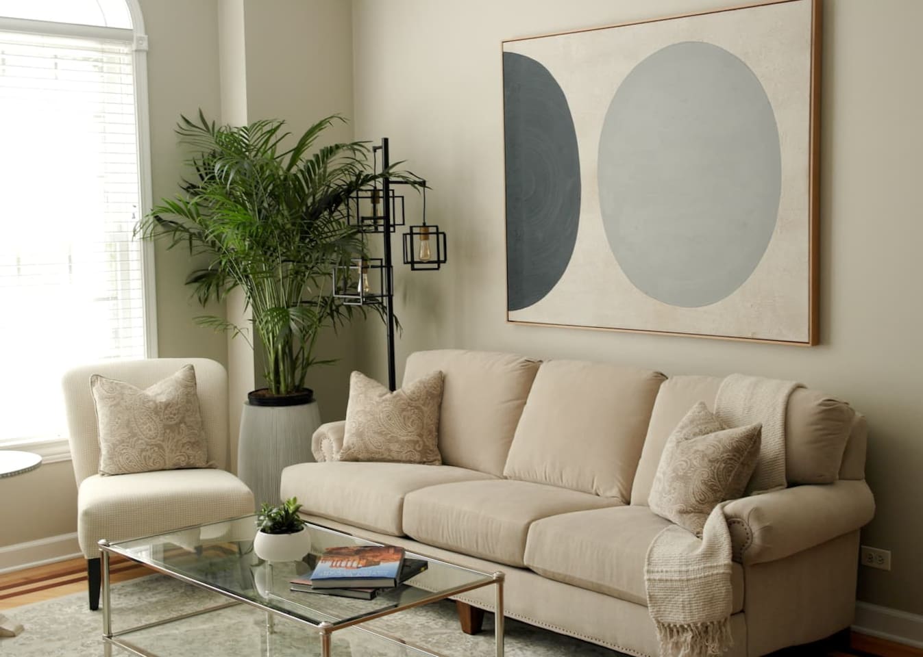 Spacious sun-filled living room with comfortable seating, smart tv, and modern decor — perfect for relaxing after exploring Chicago.