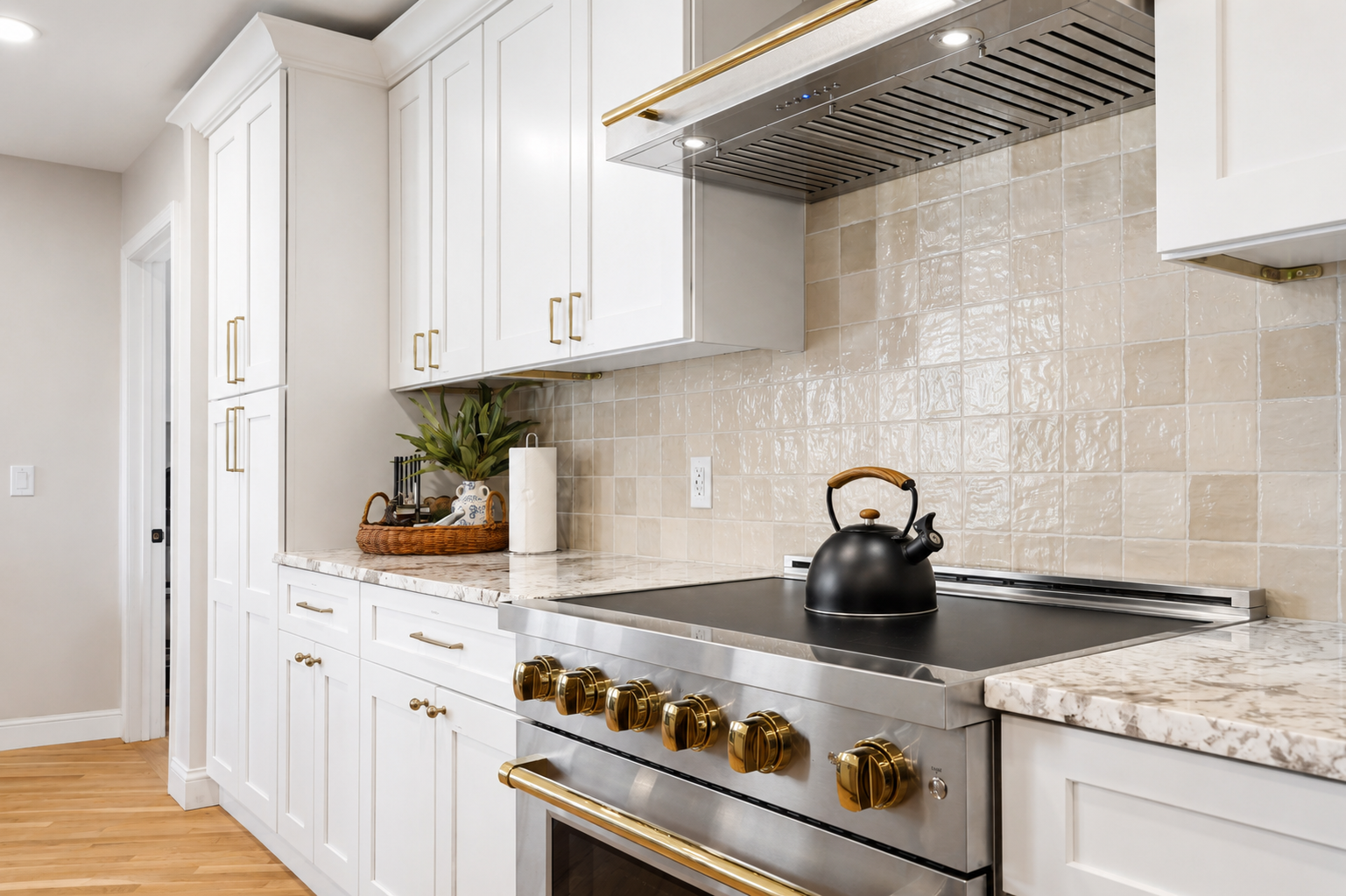 Bright, modern kitchen with quartz countertops, white cabinetry, and a professional stainless-steel range. Clean, elegant design with warm finished perfect for cooking, dining, and entertaining.