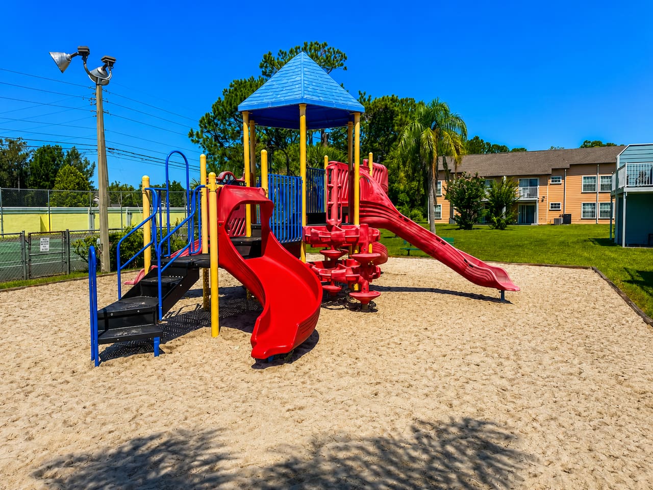 Colorful community playground with slides and climbing features for younger ones