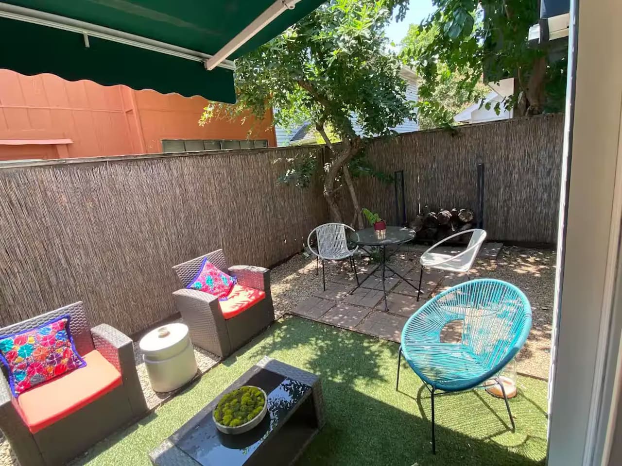 Backyard with patio seating and kid-friendly play space.