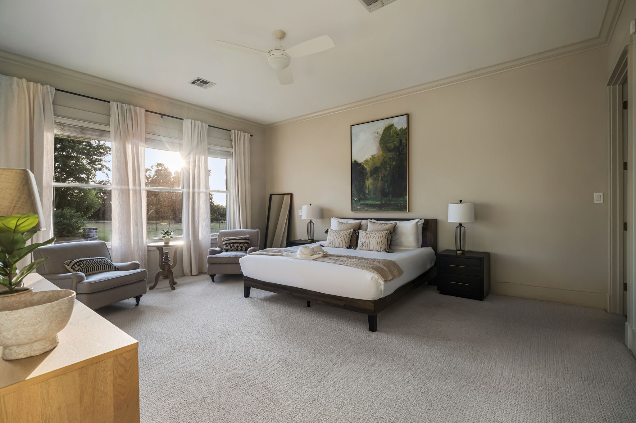 Spacious master suite featuring a king-sized bed, Smart TV, and direct access to the outdoors.