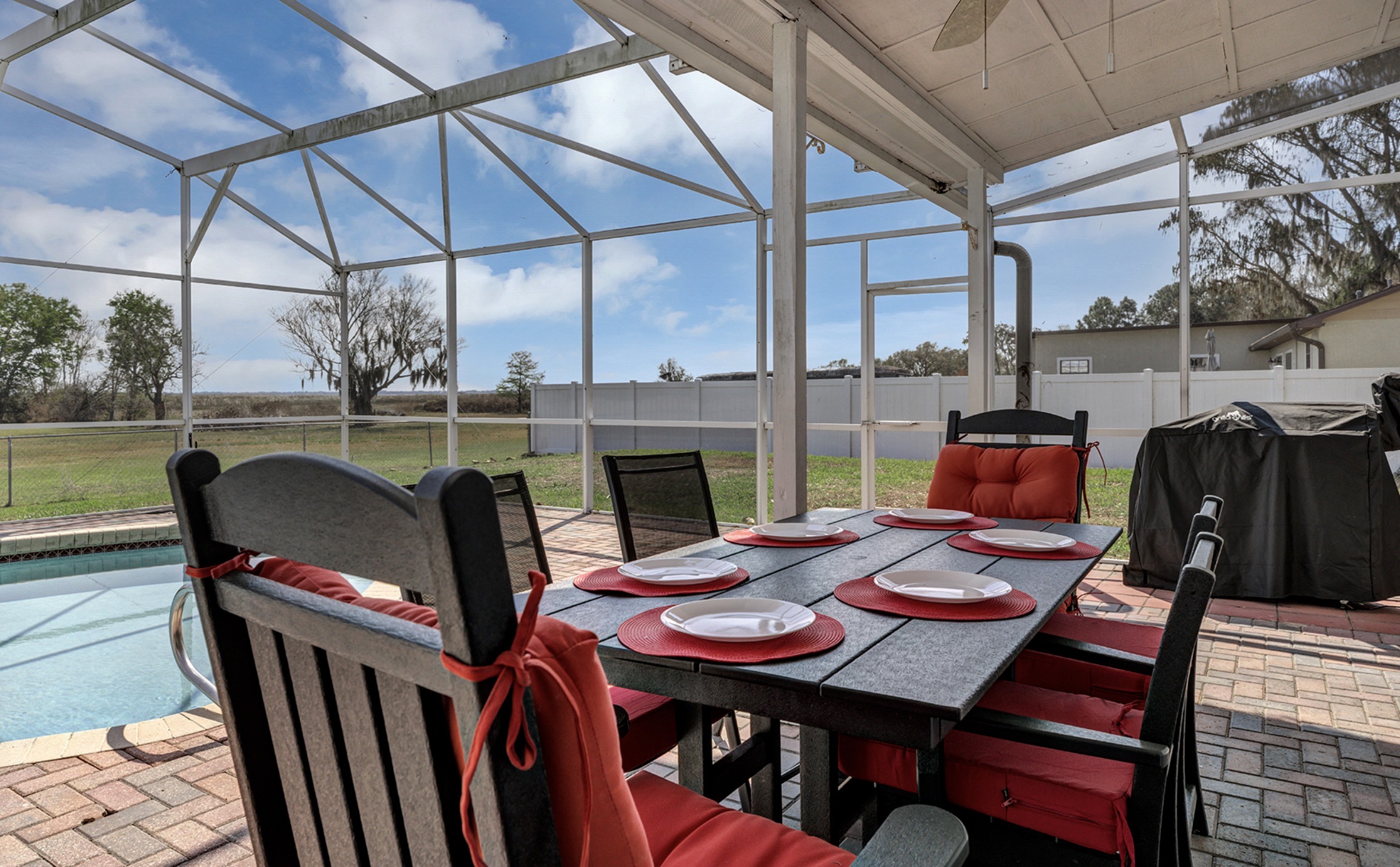 Outdoor poolside dining.  Mini frig and Grilla brand pellet grill make delicious meals