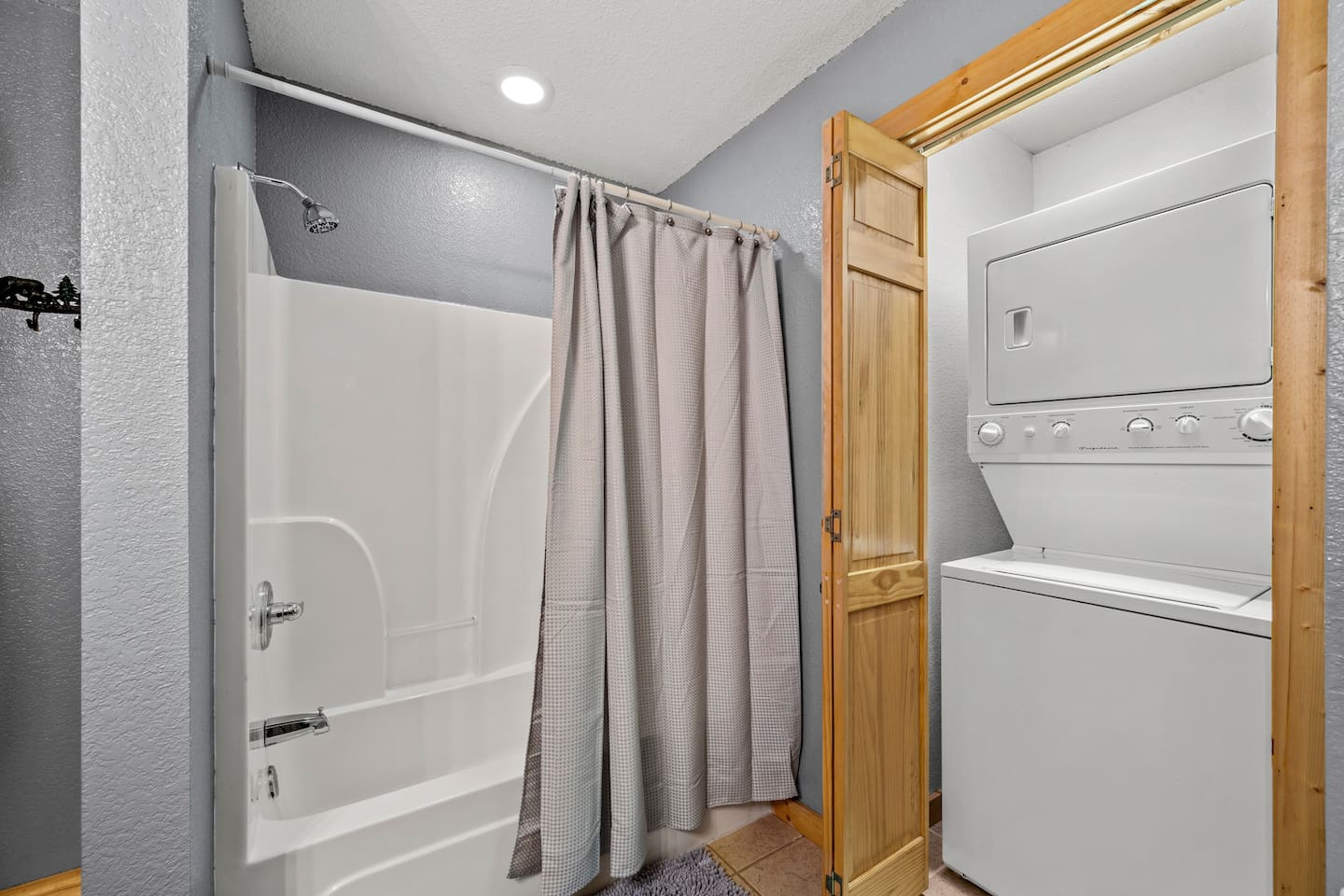 Main level full bathroom with washer and dryer