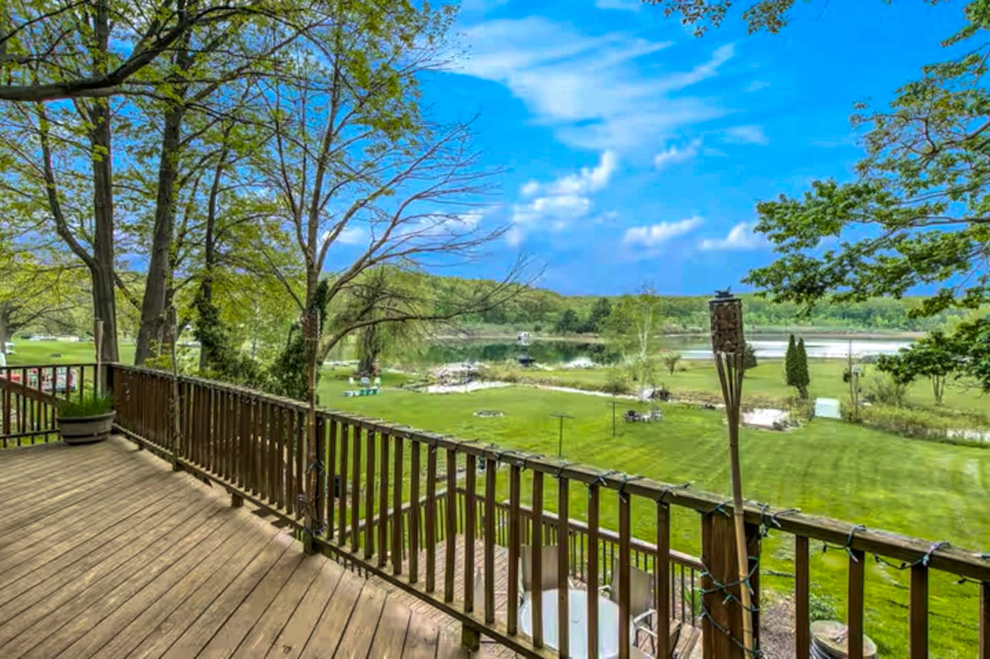 Very spacious yard that leads down to the lake with your own private dock. Also not shown here is a large seating area with a fire pit in center of yard.